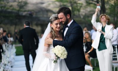 Beautiful outdoor wedding ceremony featuring a happy bride and groom embracing.