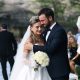 Beautiful outdoor wedding ceremony featuring a happy bride and groom embracing.